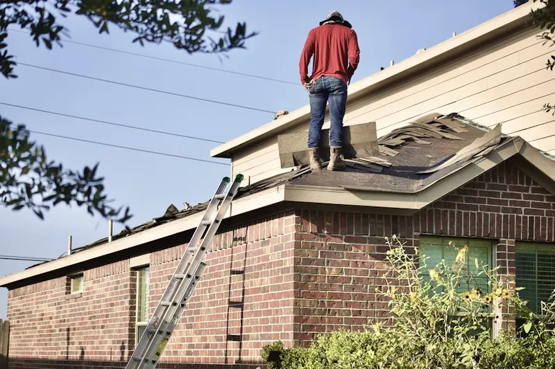 Professional roofer working on a residential roof in Tylersville